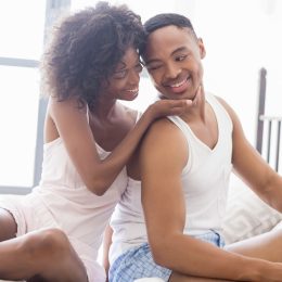 young black couple smiling at each other in the morning