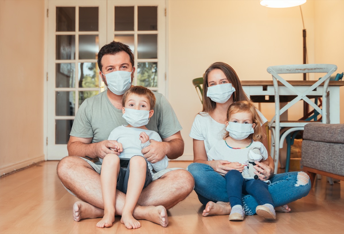 a family wears face masks at home