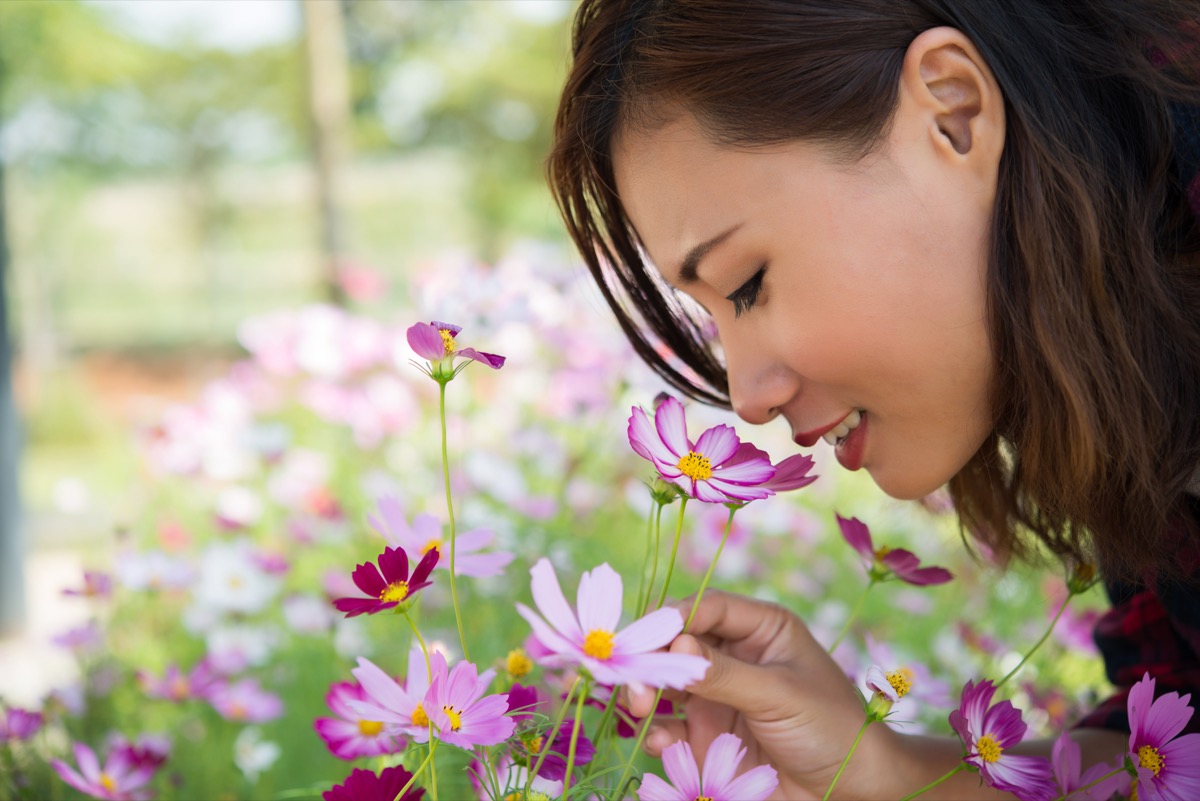 Womans smelling flowers
