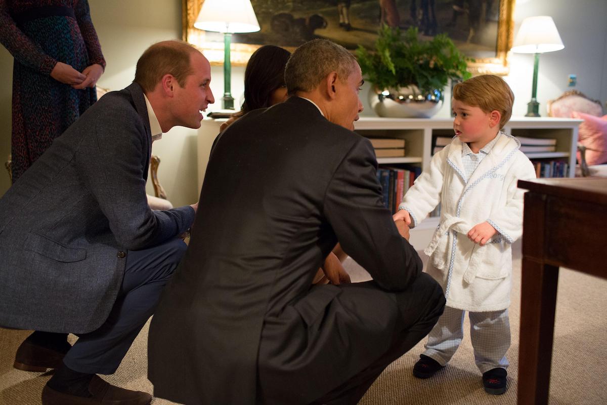 U.S President Barack Obama is introduced to Prince George in his bathrobe and pajamas as his parents, Prince William, the Duke of Cambridge and Kate Middleton, Duchess of Cambridge look on at Kensington Palace April 22, 2016 in London, United Kingdom