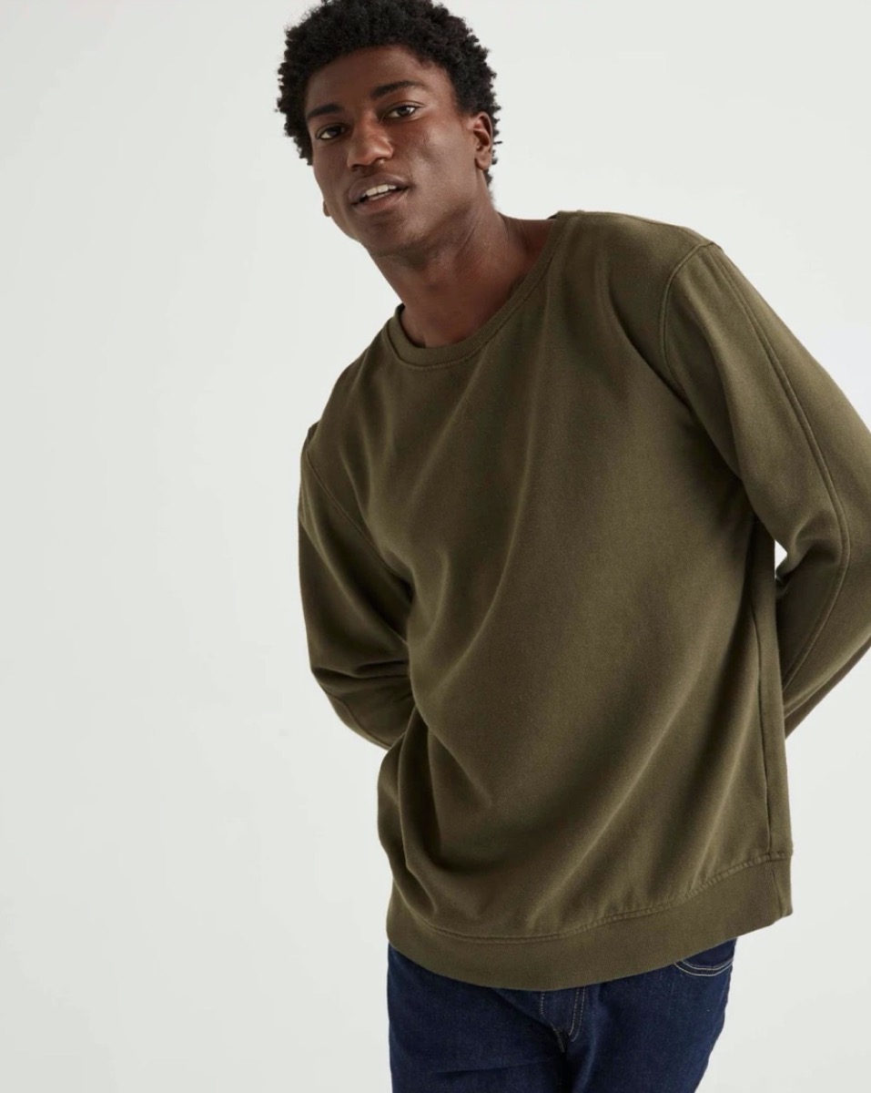 young black man in green sweatshirt