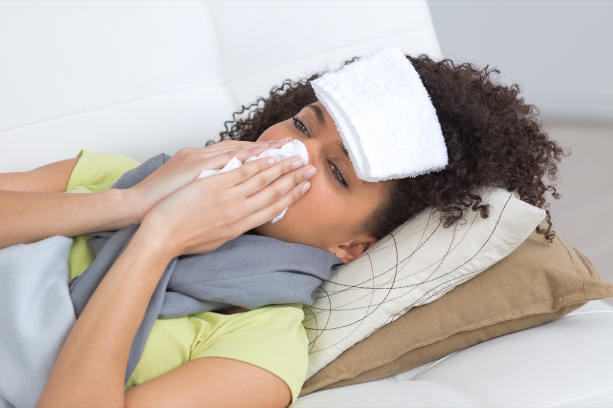 Woman with the flu at home laying down