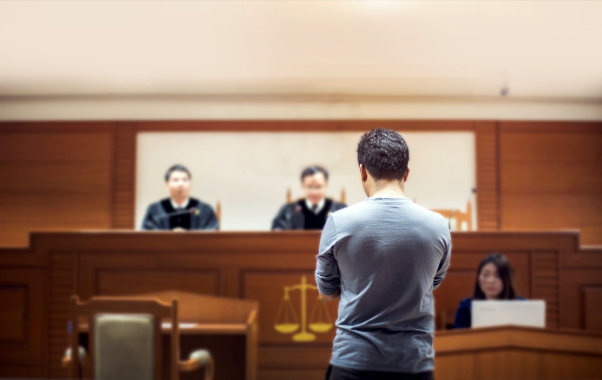 man in courtroom in front of judge