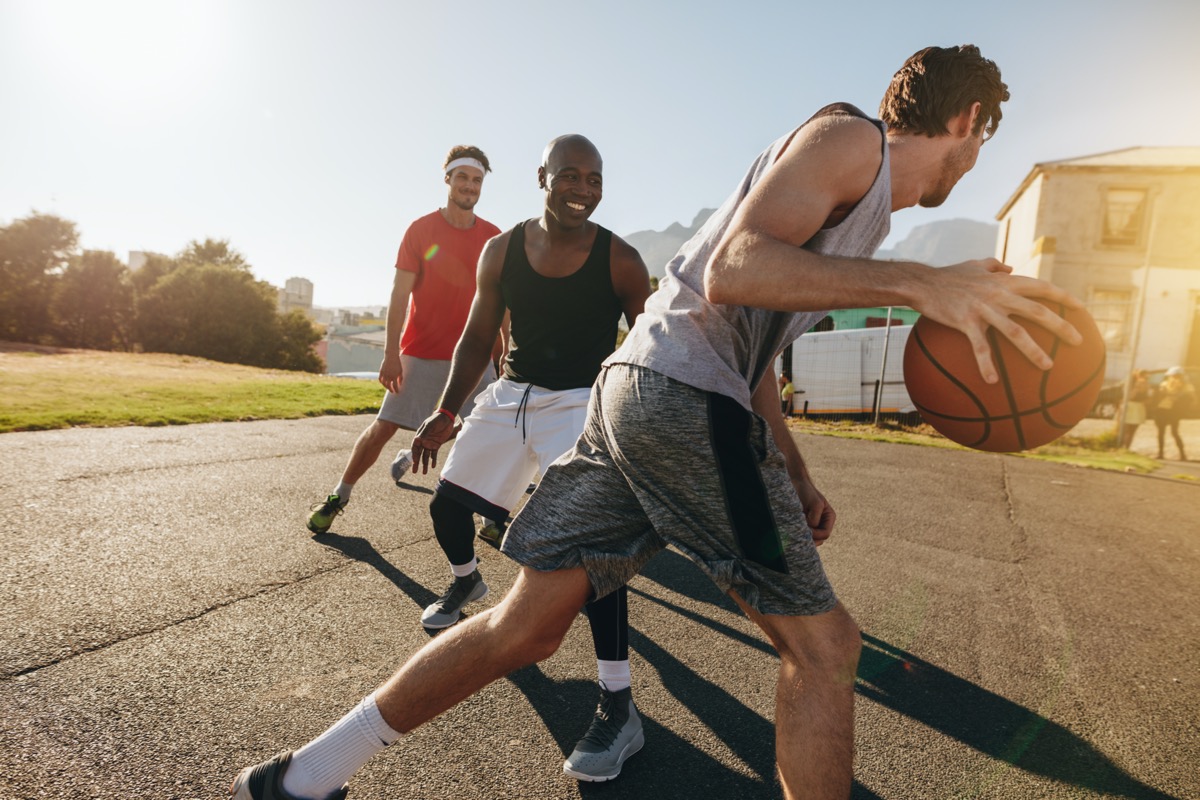 men playing basketball outside