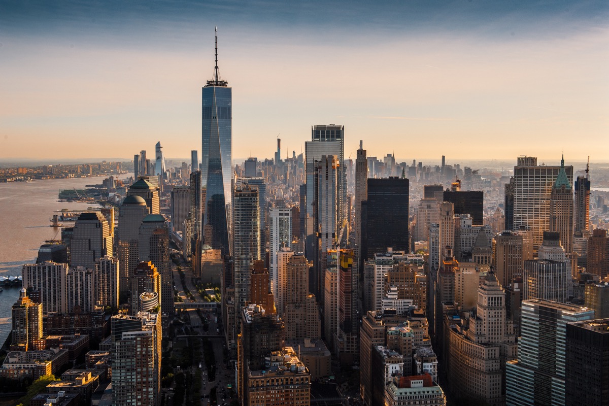 The vast skyline of Manhattan island taken from a helicopter at a golden hour.