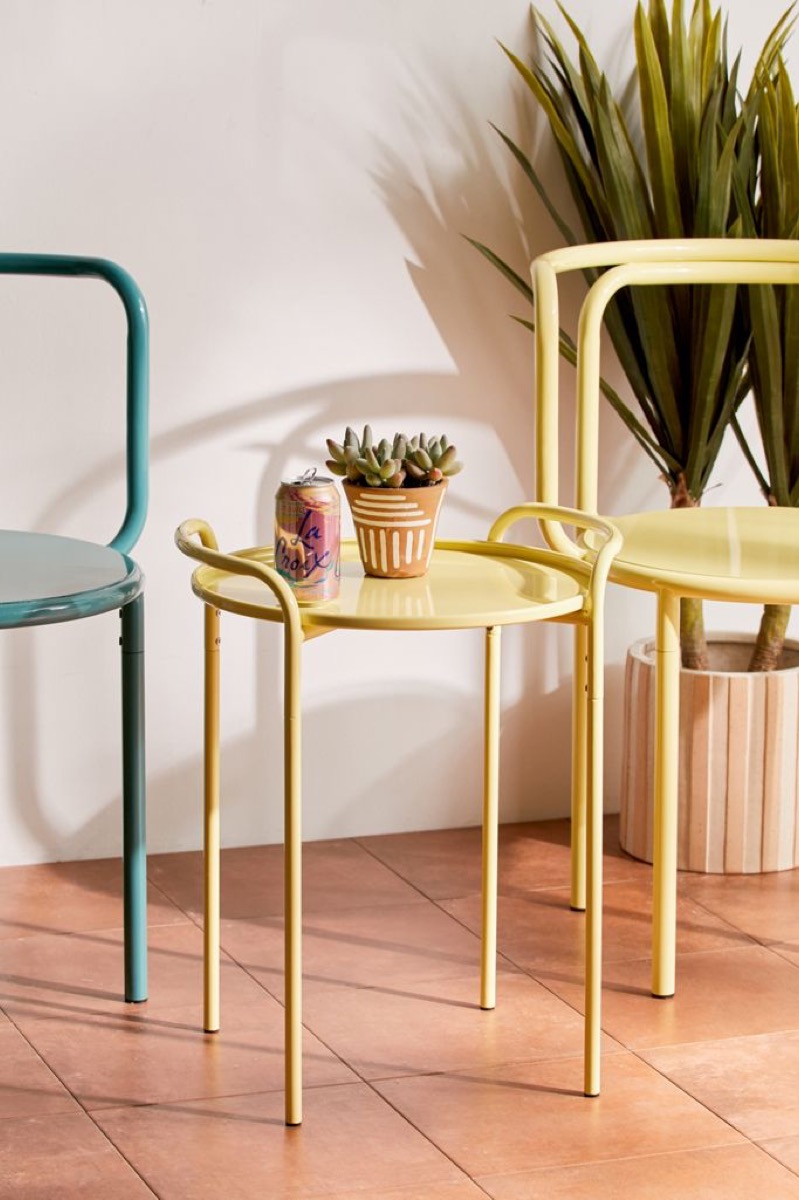 yellow enamel table between two chairs