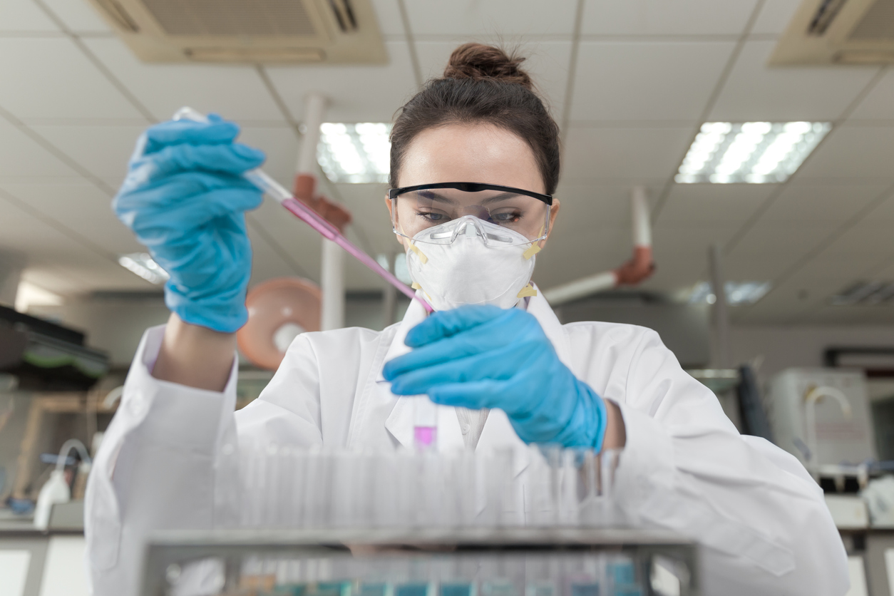 Scientist working in a laboratory using a pipette