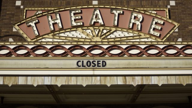 a vintage theater marquee with a closed sign