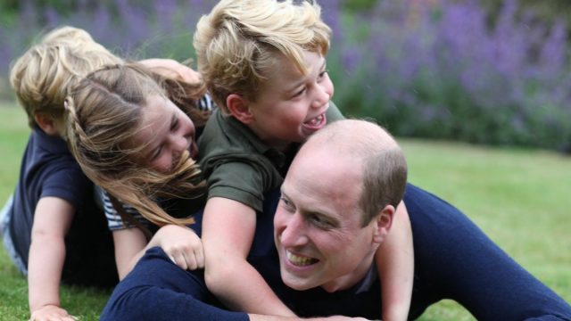 prince william plays in grass with prince george, princess charlotte, and prince louis