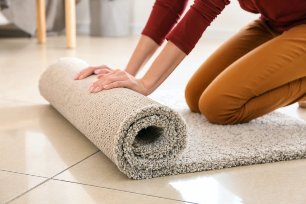 white woman rolling out shag carpet