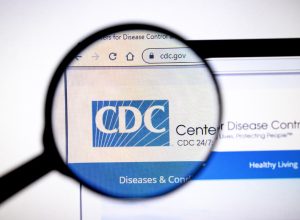 Magnifying glass viewing CDC webpage