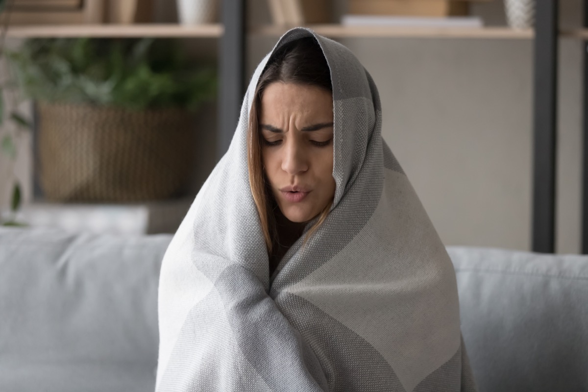 Sick woman wrapped in blanket