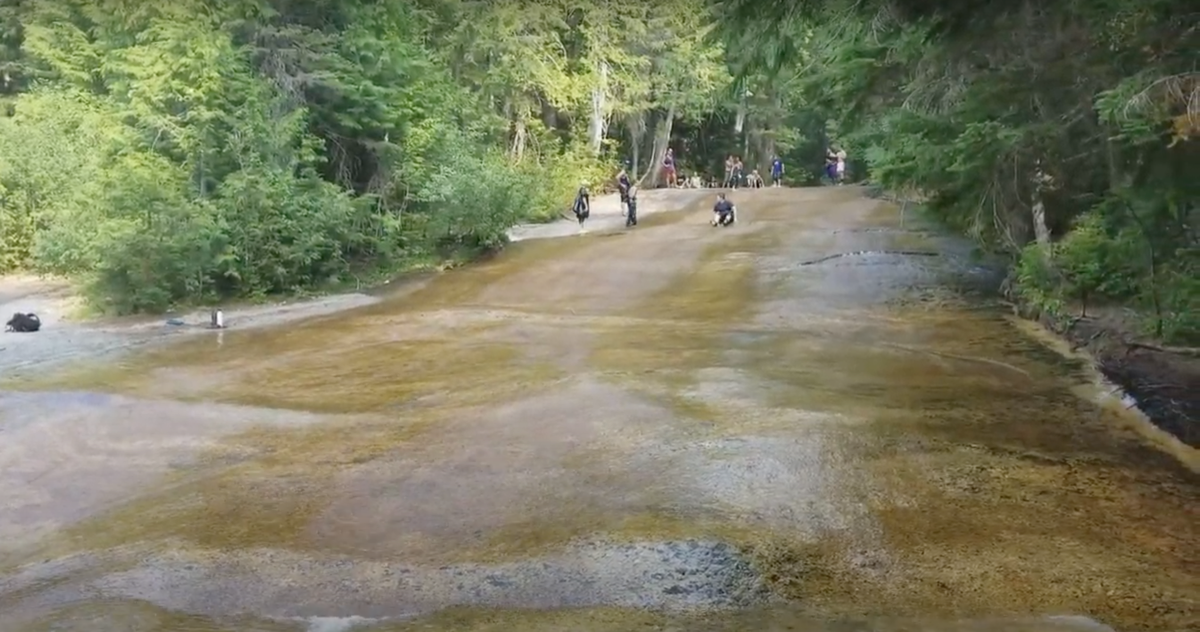 kids slide down Lionhead Natural Water Slides-Priest Lake State Park Idaho