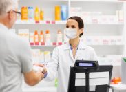 Man buying something from pharmacist with mask on