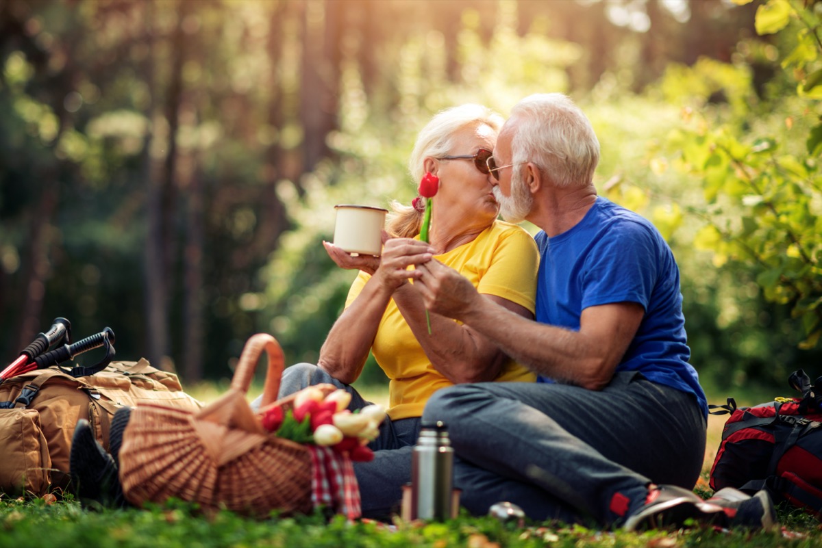 Senior couple kissing on picnic