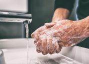 Person washing hands with soap