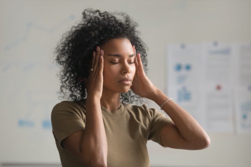 Young black woman having migraine