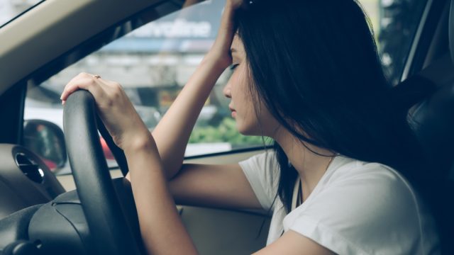Woman experiencing fatigue while driving