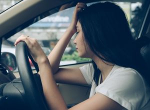 Woman experiencing fatigue while driving