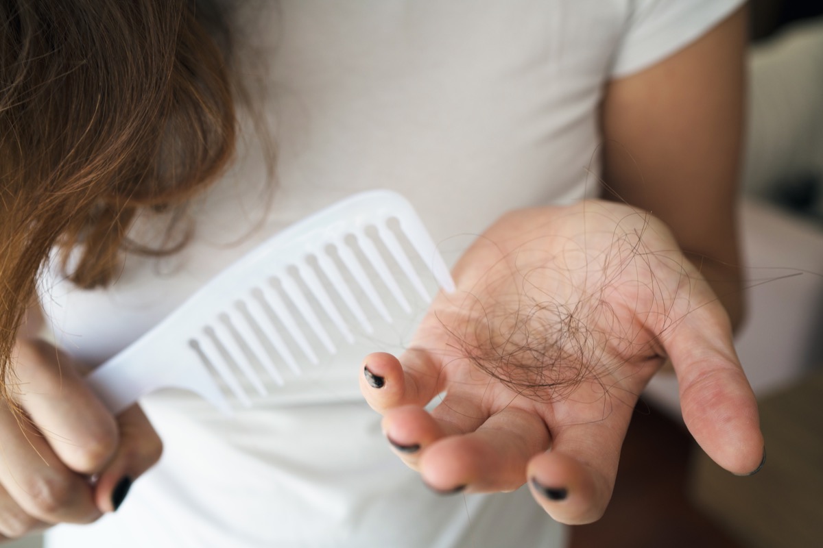 woman holding handful of hair
