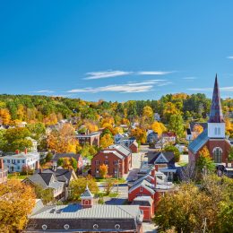 The skyline of Montpelier, Vermont in autumn with brick buildings and a church steeple