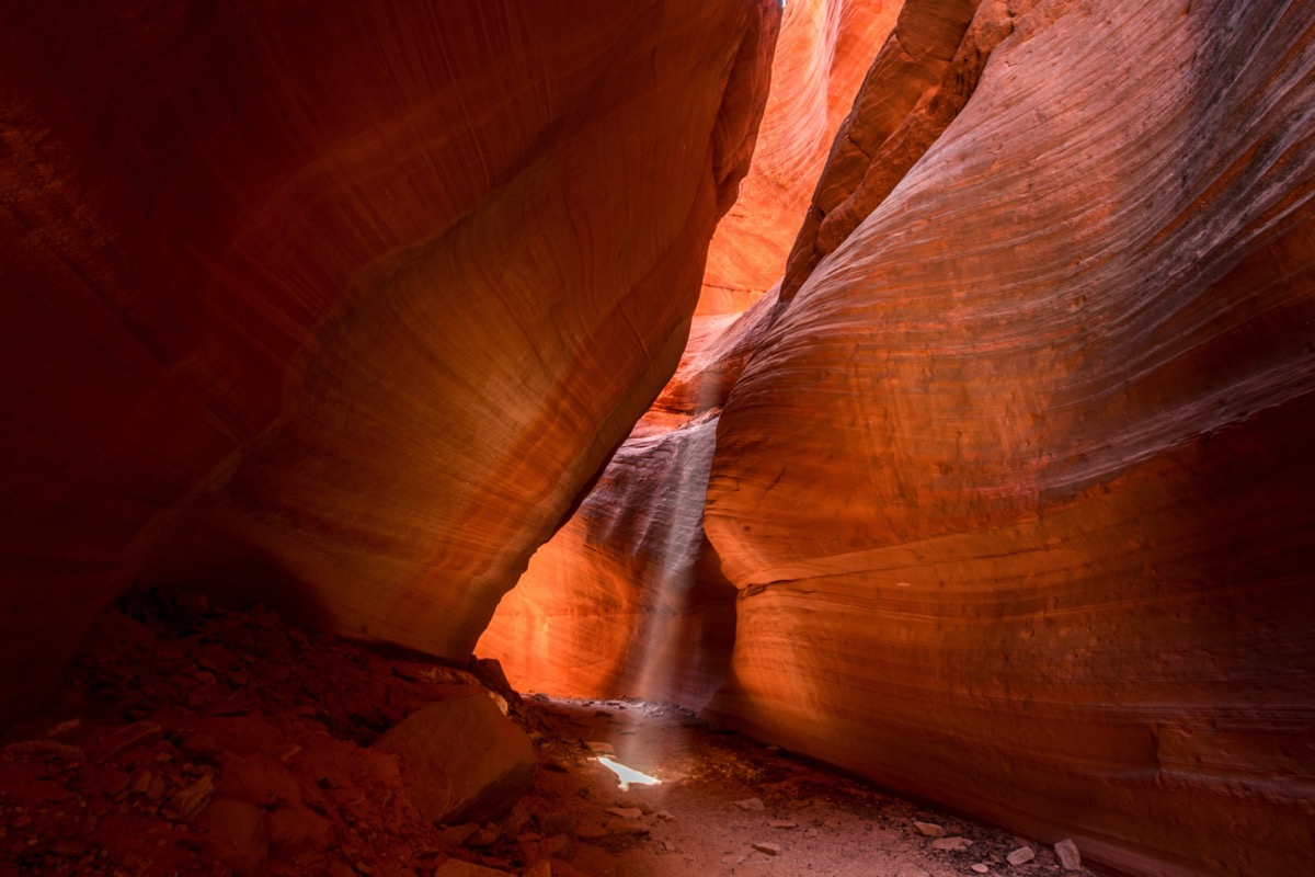 light beam shines through a slot canyon