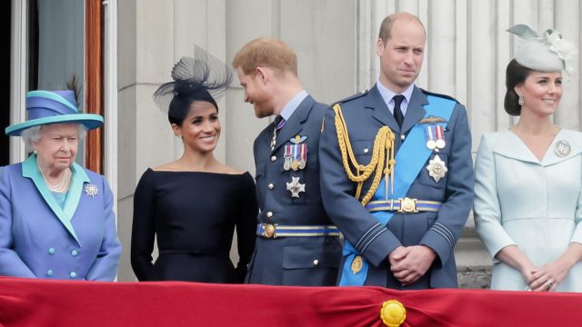 Queen Elizabeth, Meghan Markle, Prince Harry, Prince William, andKate Middleton watching the flypast from Buckingham Palace Balcony to commemorate 100 years of the RAF