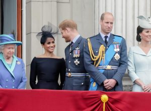 Queen Elizabeth, Meghan Markle, Prince Harry, Prince William, andKate Middleton watching the flypast from Buckingham Palace Balcony to commemorate 100 years of the RAF
