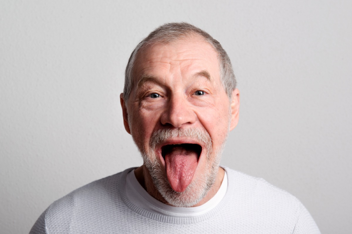 Senior man sticking out tongue