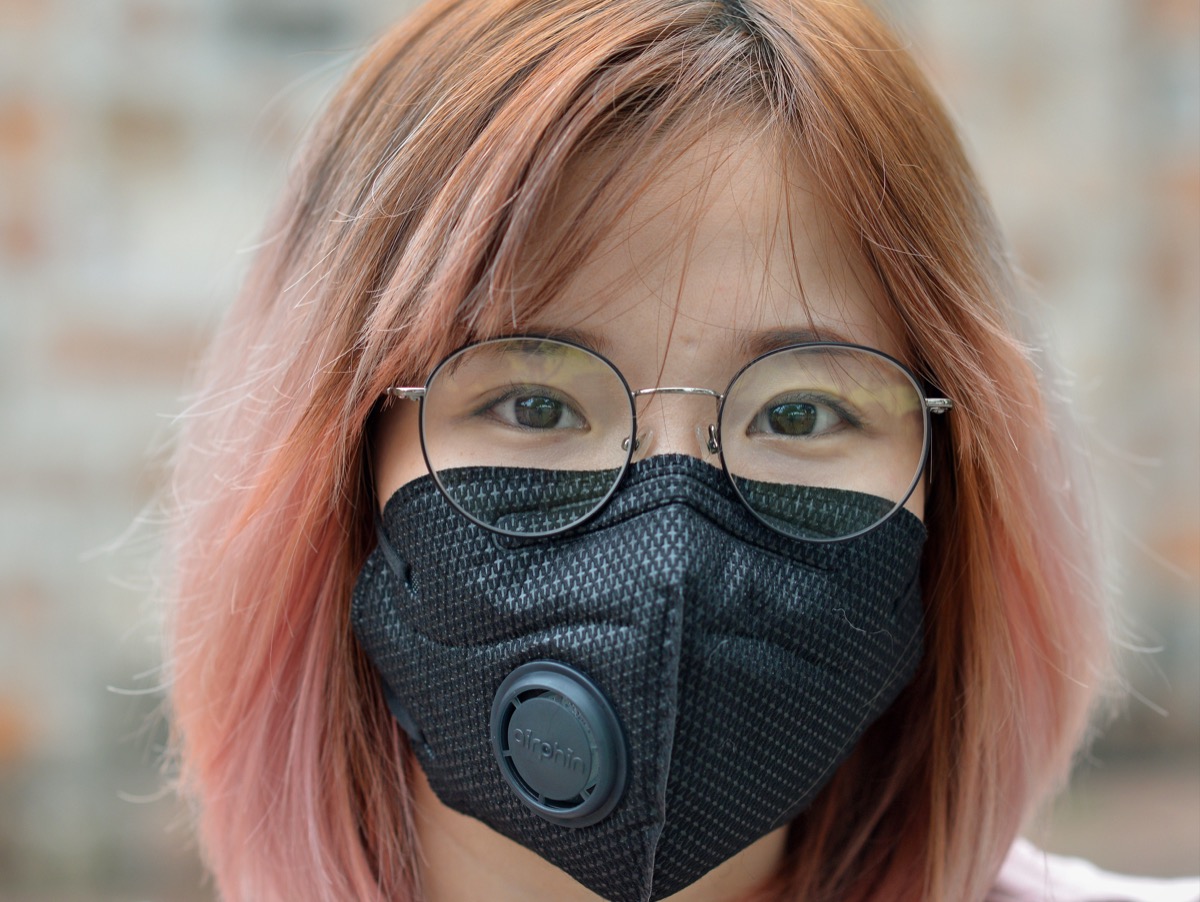 Girl wearing a face mask with a valve in it