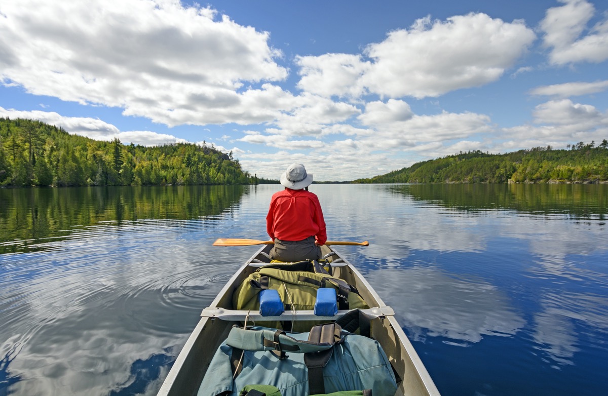 man canoeing in minnesota