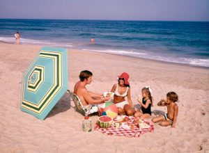 family has a beach picnic in the 1970s