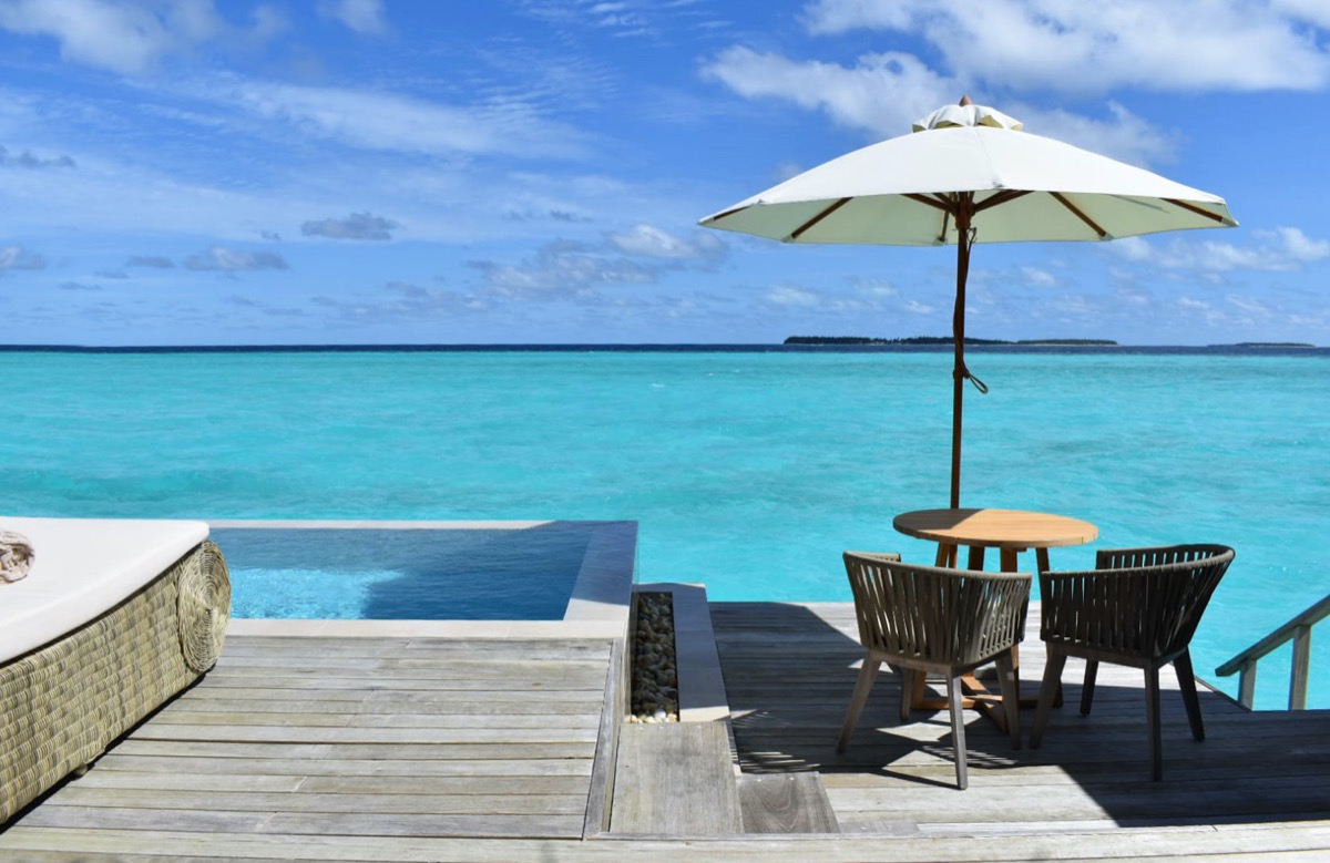 pool and water view off the deck of an overwater bungalow at the Baglioni Resort Maldives