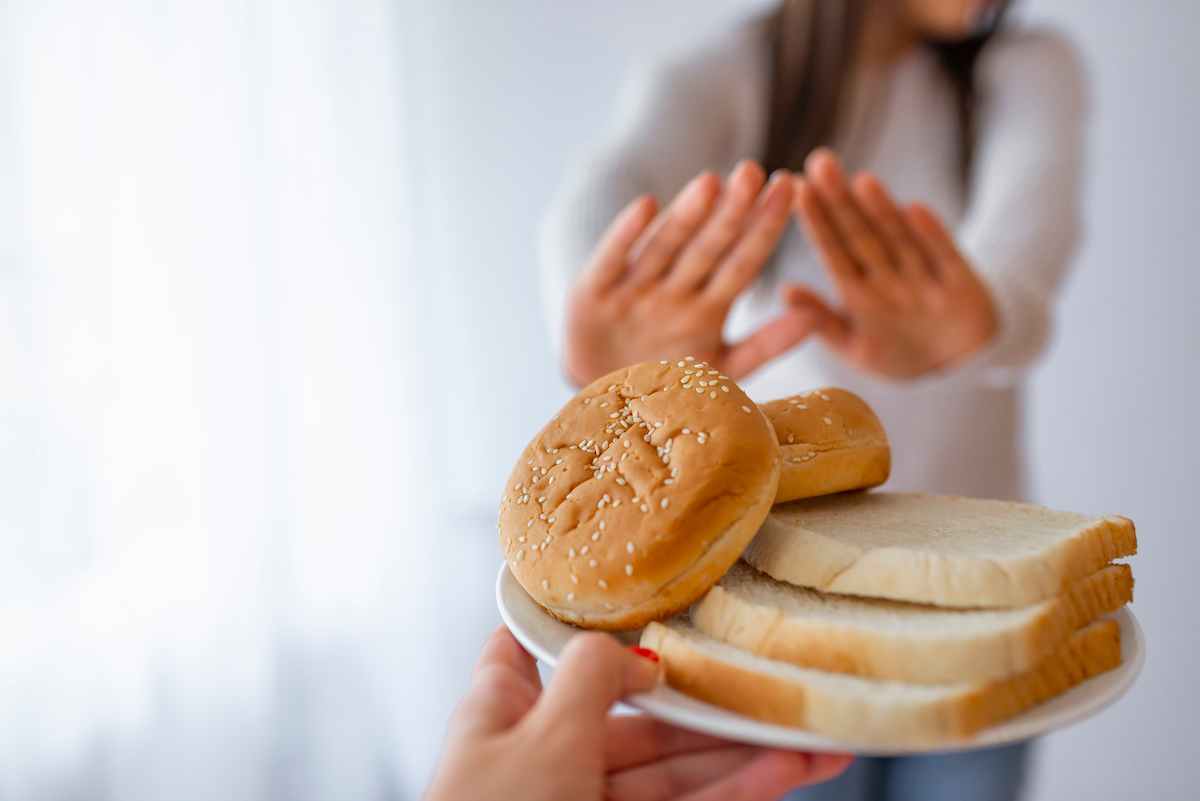 Celiac disease; woman avoiding bread