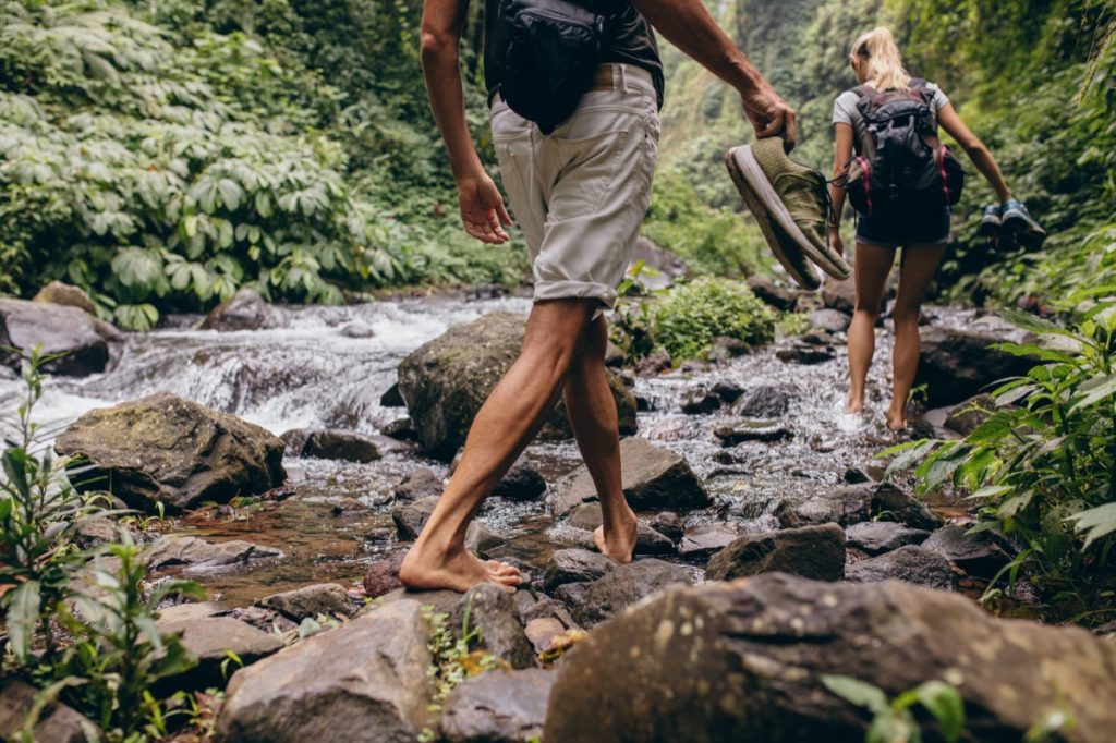 couple hiking in stream