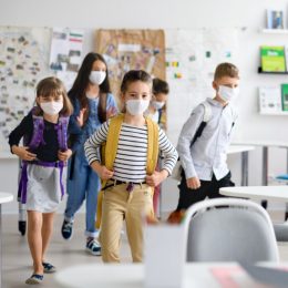 Elementary age school kids at school in mask