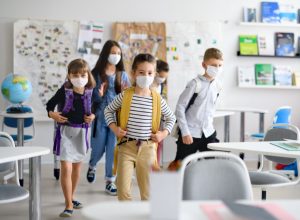 Elementary age school kids at school in mask