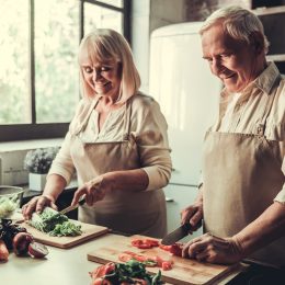 Older couple cooking vegetables