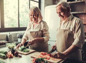 Older couple cooking vegetables