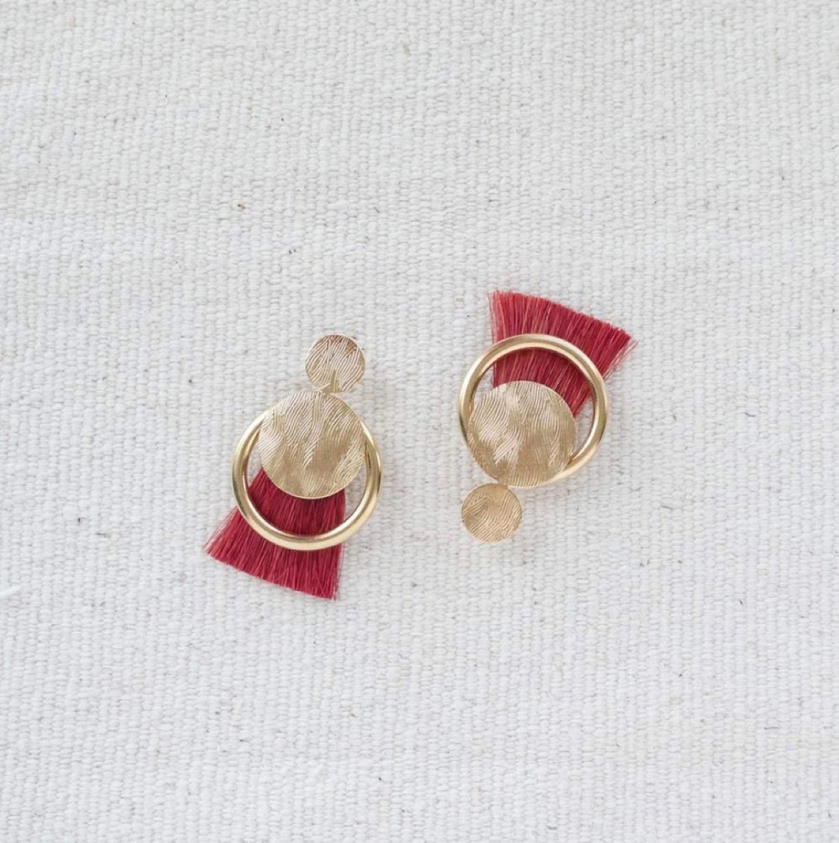 gold earrings with red tassels