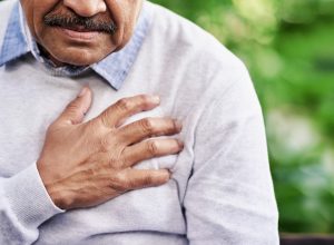 Man holding his chest because of heart pain