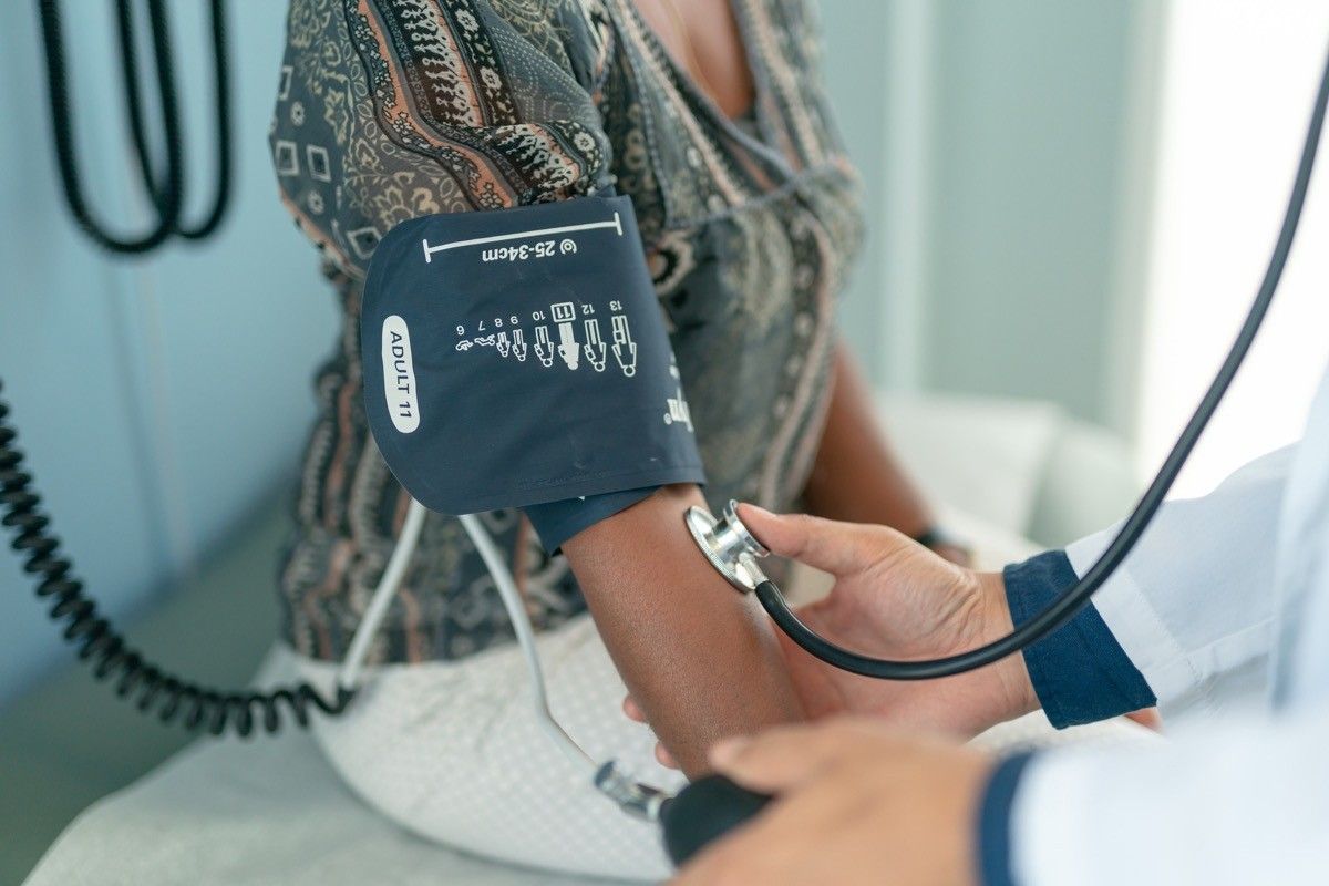 Woman getting her blood pressure checked by doctor