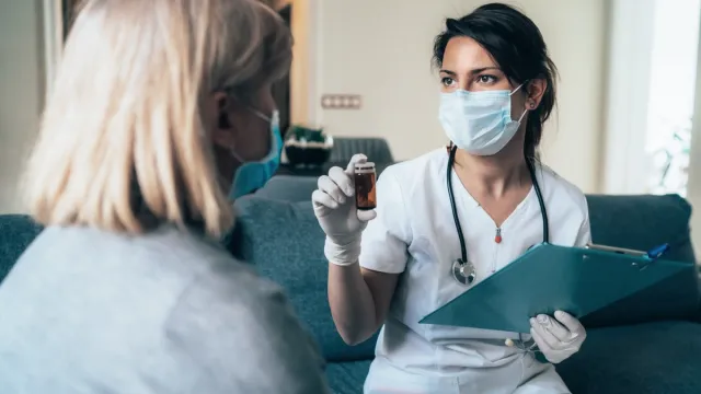 Female doctor consults mature patient during the quarantine for coronavirus