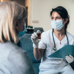 Female doctor consults mature patient during the quarantine for coronavirus