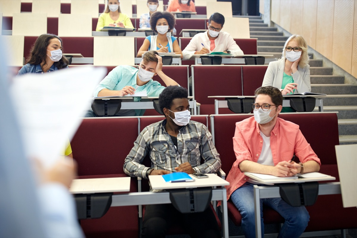 students wearing masks in college lecture hall