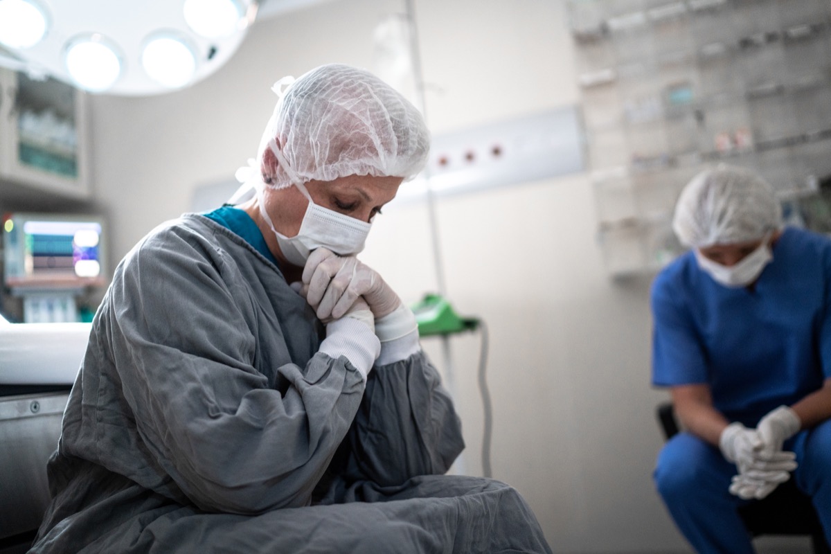 Worried healthcare coworkers at operating room in hospital