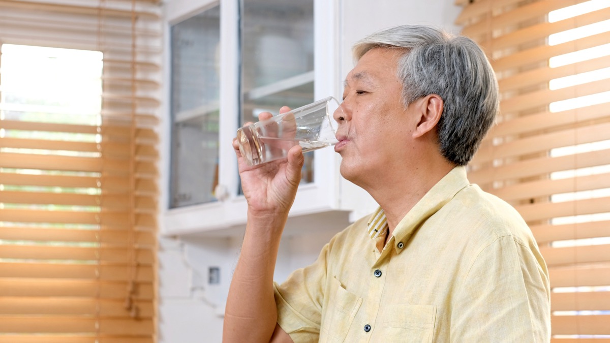 Extremely thirsty man drinking water