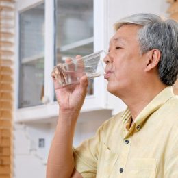 Older man drinking water