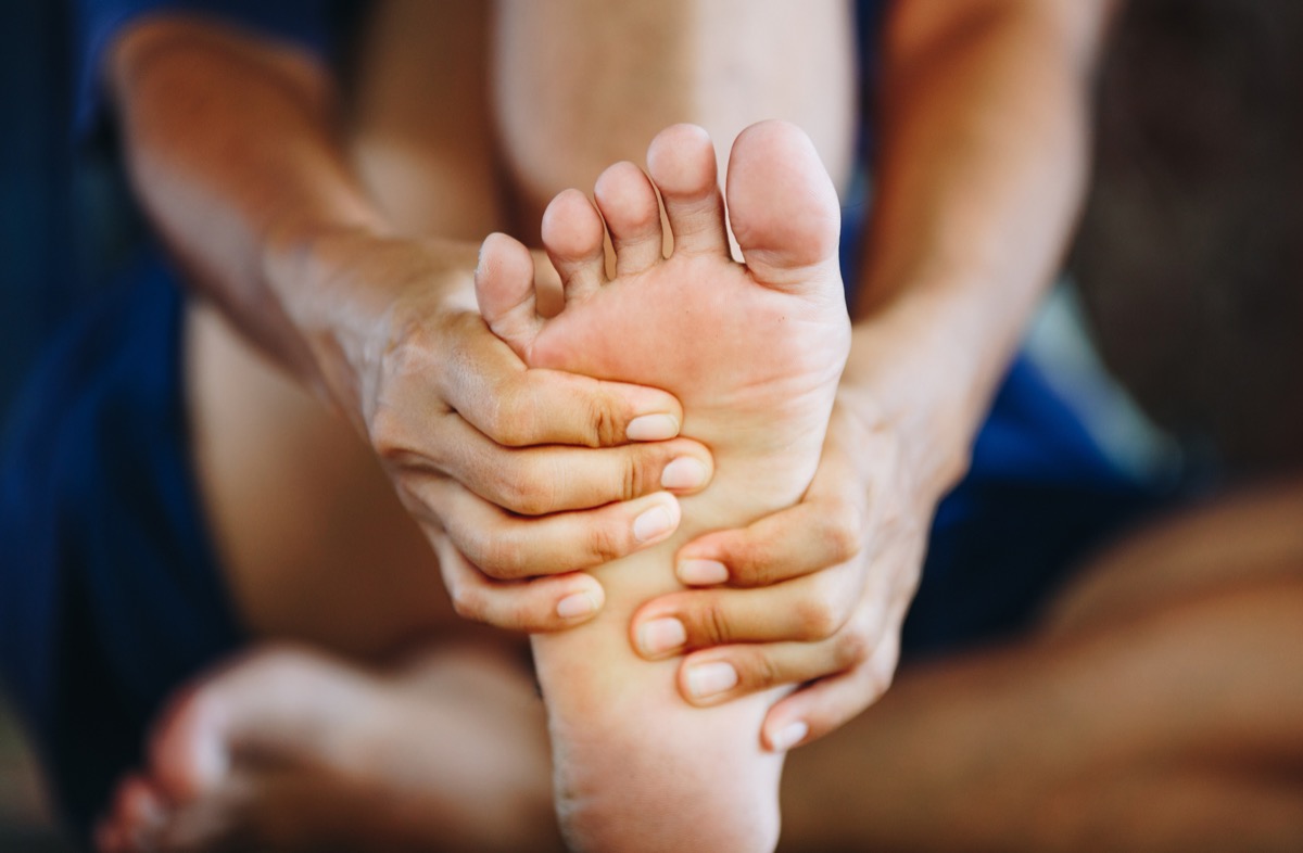 Massaging foot to get rid of pain