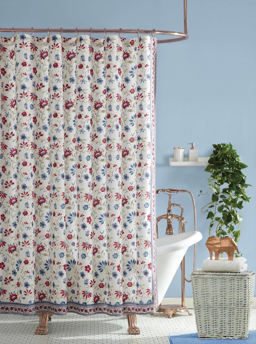 blue bathroom with white floral shower curtain